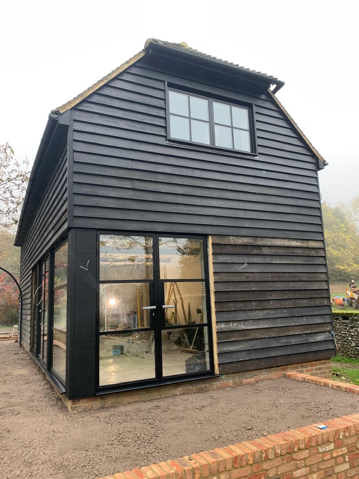 Black timber-clad barn conversion with Heritage Doors