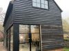 Black timber-clad barn conversion with Heritage Doors